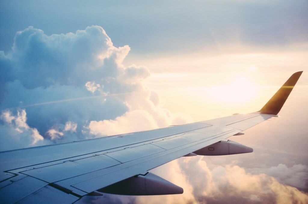 How to stay comfortable on a long flight. An airplane wing in the sky with white clouds and sun